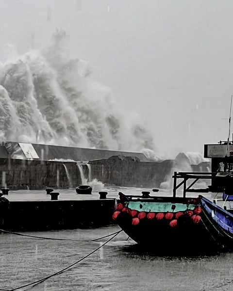 A wave crashing over a sea wall as Super Typhoon Kong-rey neared the coast in Taitung