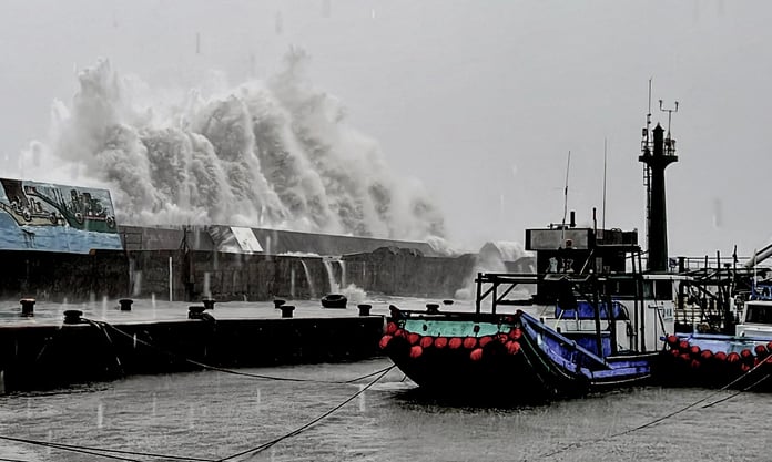 A wave crashing over a sea wall as Super Typhoon Kong-rey neared the coast in Taitung