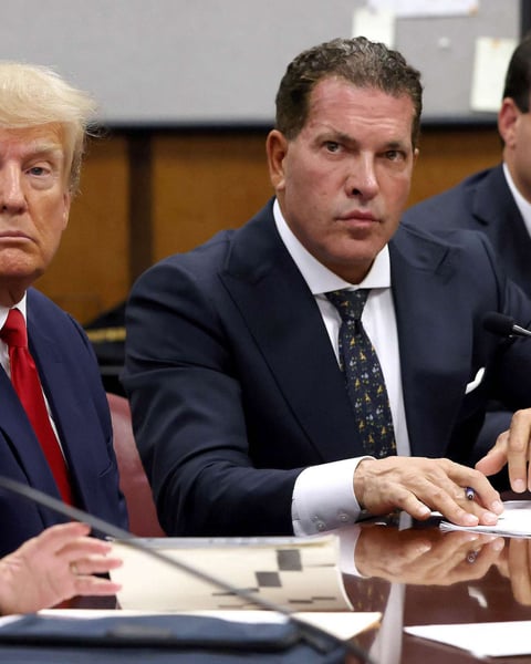 President Donald Trump sits with his attorneys Joe Tacopina and Boris Epshteyn