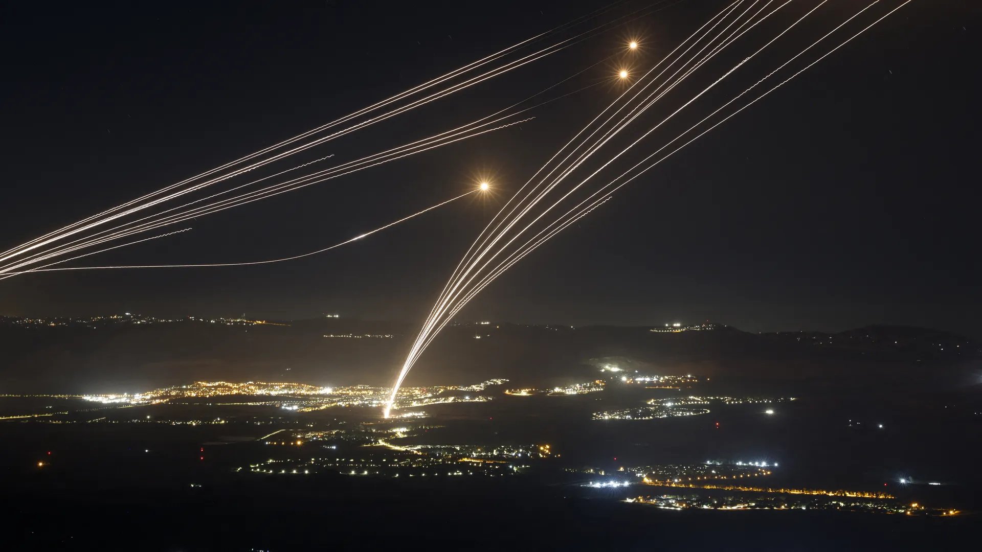 Rockets fired from southern Lebanon are intercepted by Israel's Iron Dome air defense system over northern Israel