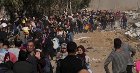 Palestinians running for shelter in Gaza during Israeli airstrikes