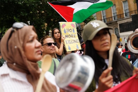 Palestinians gather at an aid distribution point amid ongoing Israeli airstrikes, Gaza City