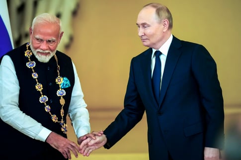 Vladimir Putin and Narendra Modi shaking hands during high-level meeting in Moscow