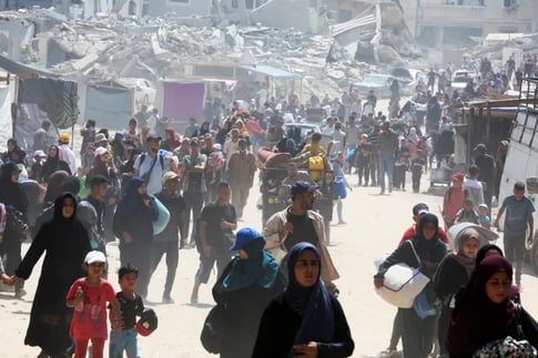 Gaza City buildings burn after Israeli airstrikes amid evacuation and US-backed escalation.
