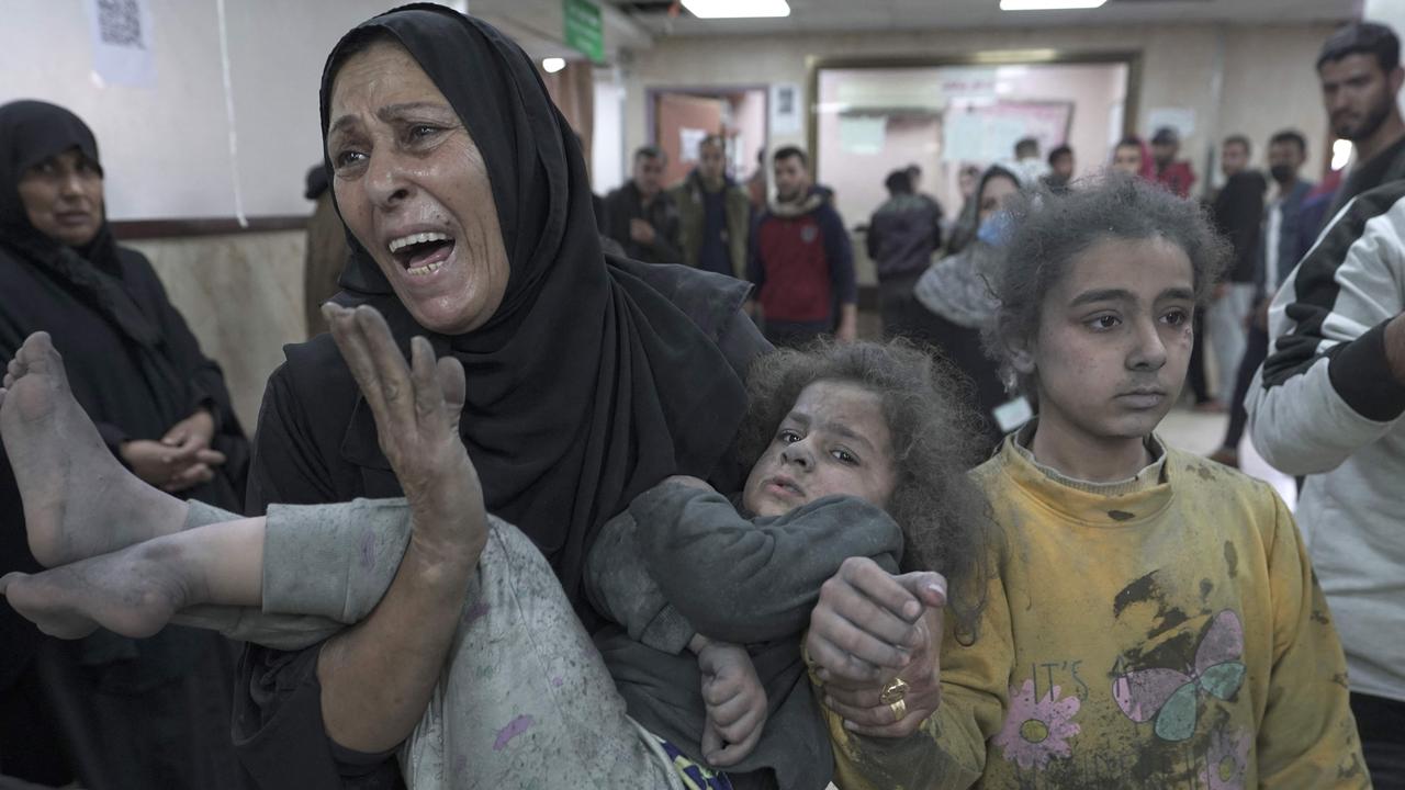 Deir Al-Balah Emergency Ward Amid Renewed Strikes A wounded child is carried through a crowded emergency room at Al-Aqsa Martyrs Hospital in Deir al-Balah.