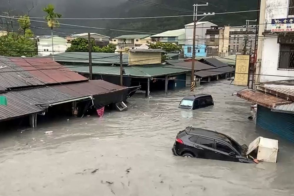 Satellite View Of Hualien Landslide-Dammed Lake Residents walk through mud in a flooded Hualien neighborhood after the barrier lake breach.