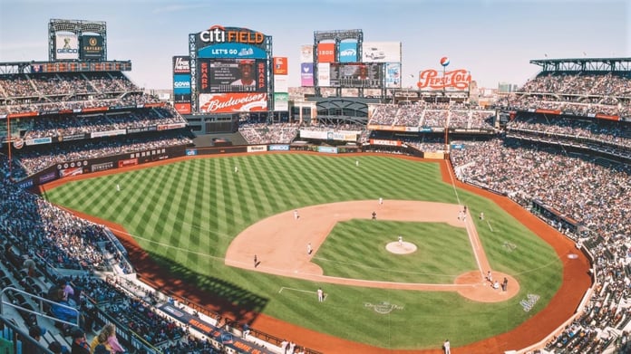 Aerial view of Citi Field and surrounding parking lots in Queens with Arthur Ashe Stadium in the background