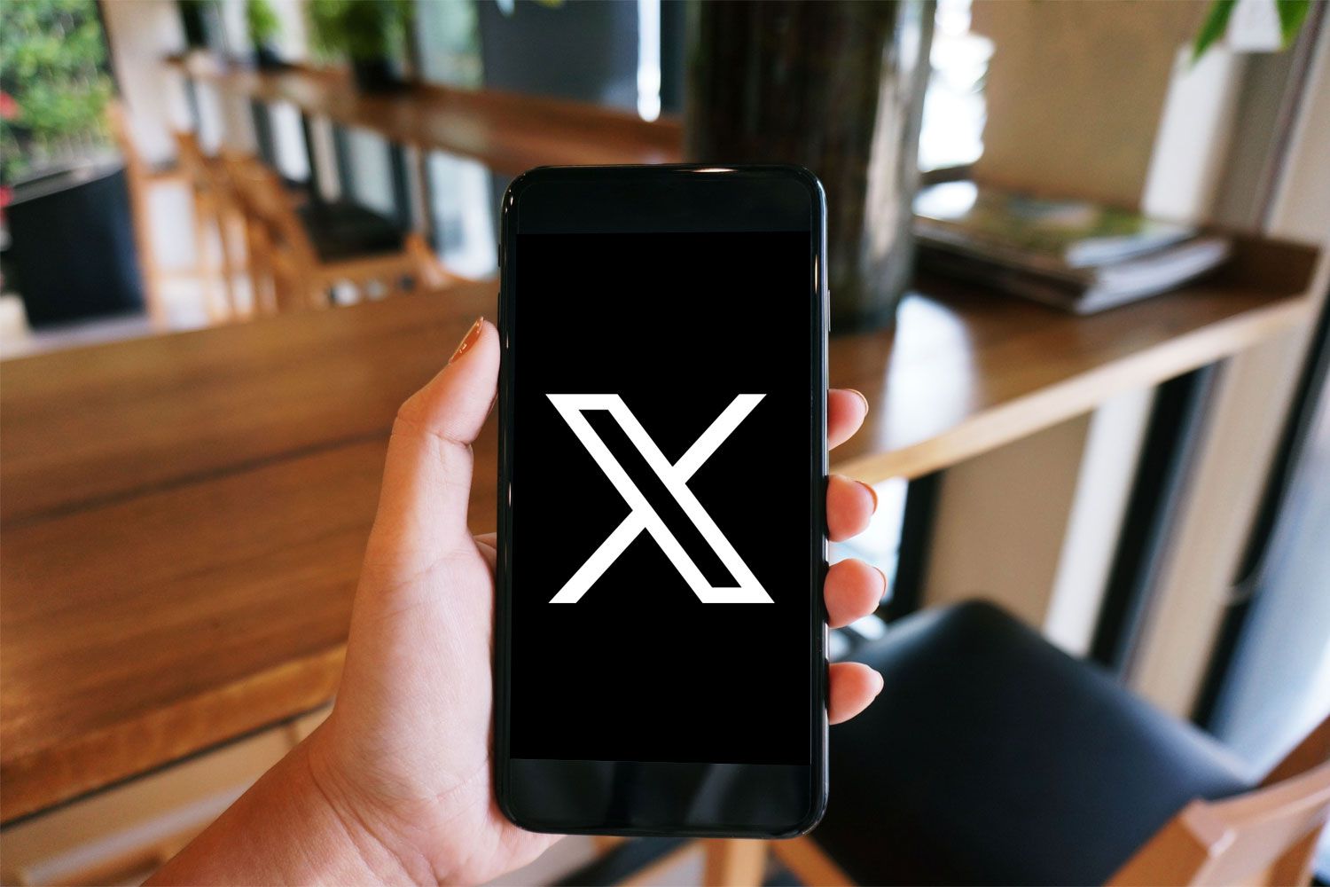 X Platform Context X logo on a smartphone to illustrate platform debates surrounding Musk news coverage