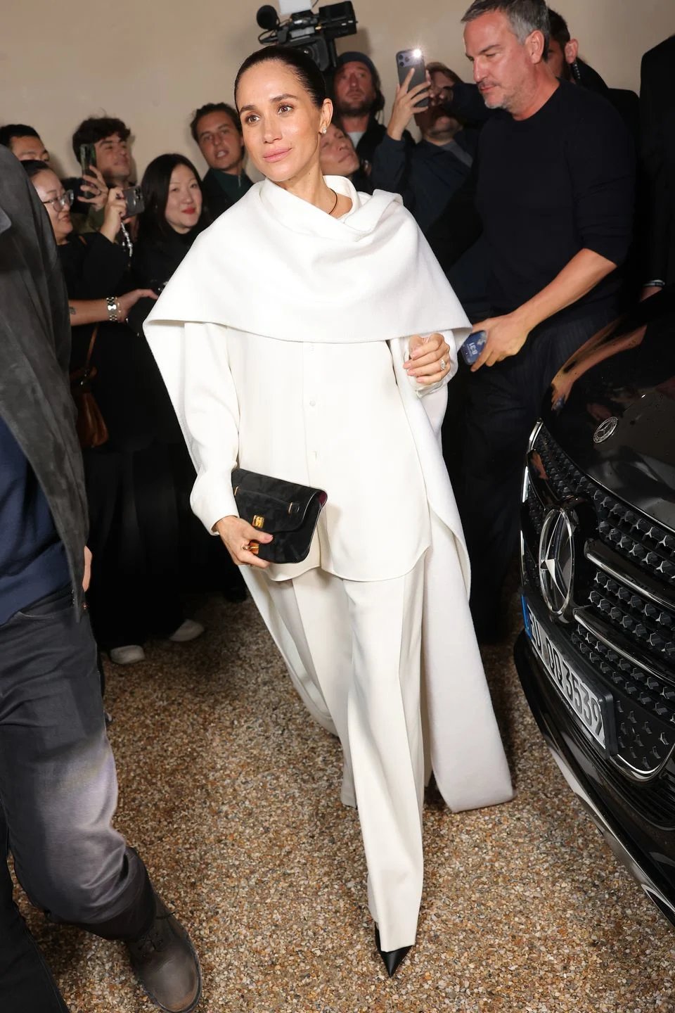 White cape front row, Balenciaga Paris Meghan Markle in a white cape at the Balenciaga show, front row at Paris Fashion Week 2025.