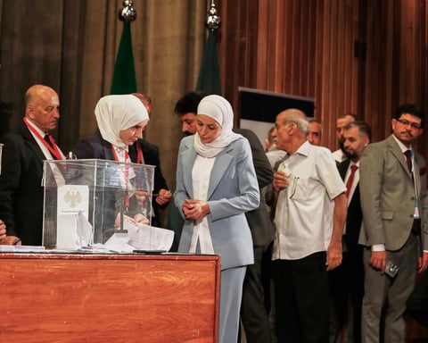 Electoral college member submits a ballot during Syria elections 2025 in Damascus