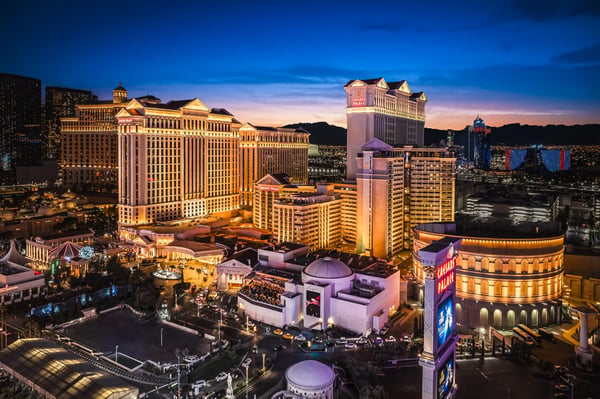 Caesars Palace casino exterior lit up at night, Las Vegas Strip.