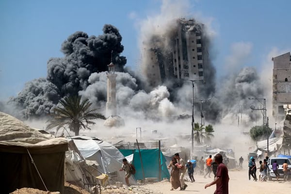 Aerial view of Gaza city with smoke and damaged buildings amid Israel-Palestine conflict, 2025