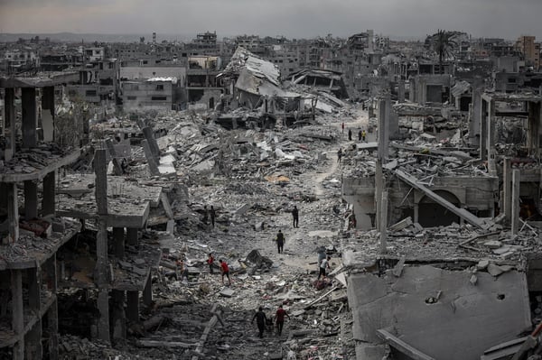 Gaza Day 716 devastation with destroyed buildings and civilians amid rubble