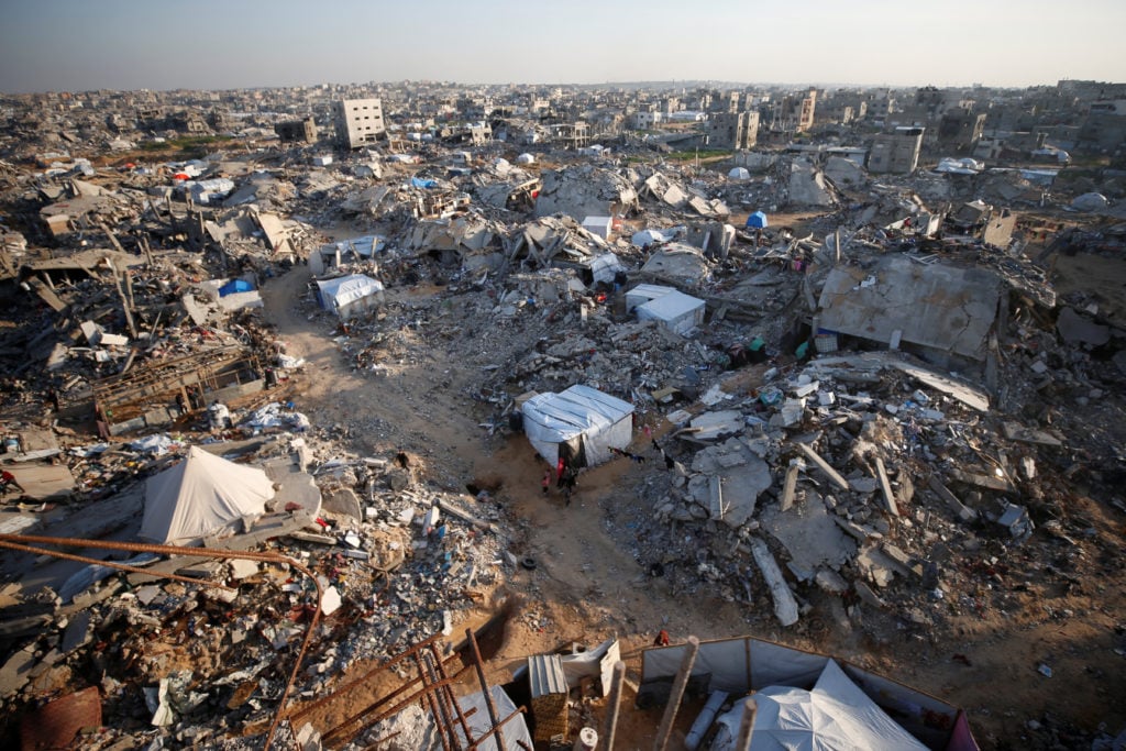 Gaza Humanitarian Crisis Continues Despite Ceasefire Displaced Palestinians amid destroyed buildings in Gaza during fragile ceasefire November 2025