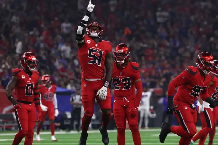 Texans defensive players celebrate after sacking Josh Allen