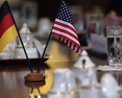 German and American flags representing diplomatic tensions over US visa bans on European activists