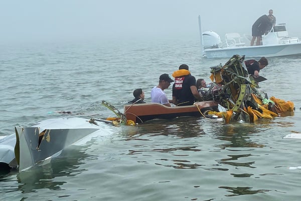 Mexican Navy aircraft crash site in Galveston Bay with Coast Guard rescue boats and emergency responders