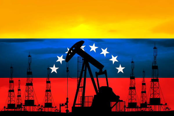 Venezuelan oil fields with pumpjacks and storage tanks at sunset