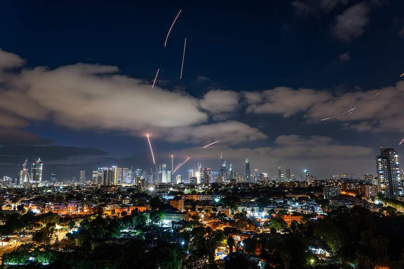 Iran missile barrage intercepted over Tel Aviv Missile defense systems intercept Iranian strikes over Tel Aviv night sky
