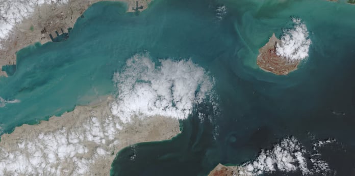 Satellite view of Strait of Hormuz showing tanker congestion during Israel attacks Iran war and US naval blockade