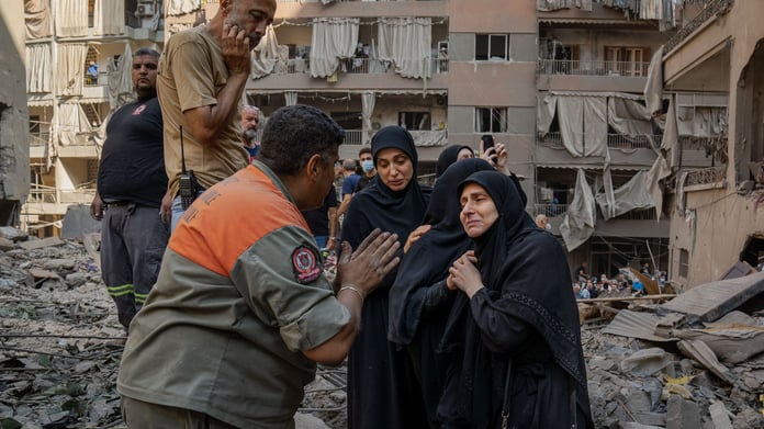 Aftermath of Israeli airstrikes in Beirut with rubble and rescue teams after 300 killed