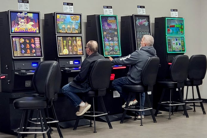 Players using slot machines inside a US casino environment