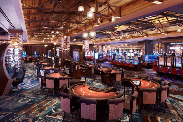 Players using slot machines inside a US casino environment