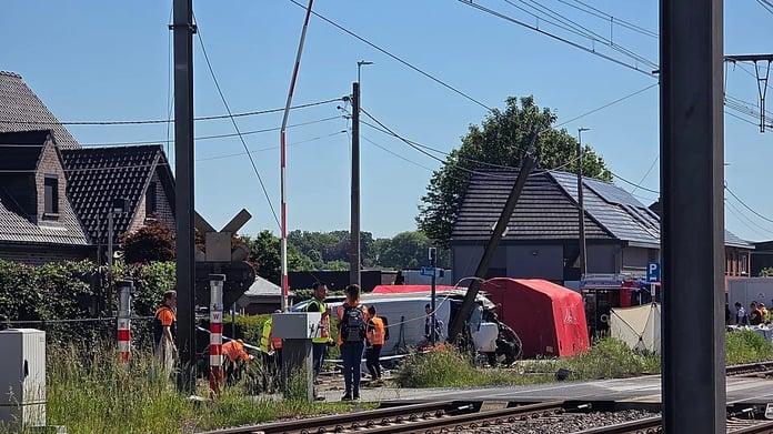 Rescue workers at the scene of a crash between a train and a school minibus at the Vierhuizen level crossing in Buggenhout, Belgium