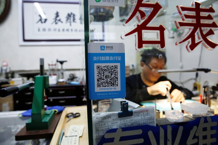 Chinese tourists using QR code mobile payments at Southeast Asia street market