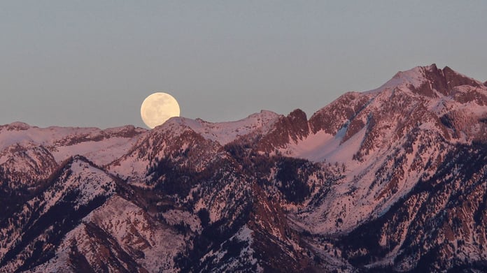 Flower Moon rising on May 1, 2026 over spring landscape with Scorpio constellation in night sky