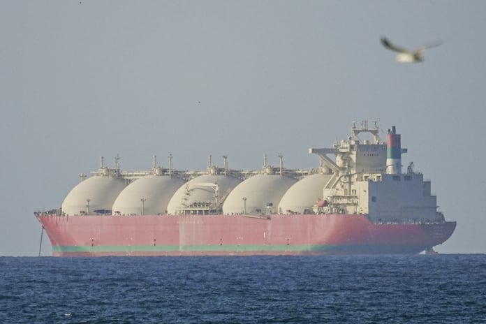 Iranian naval patrol boats operating near oil tankers in the Strait of Hormuz