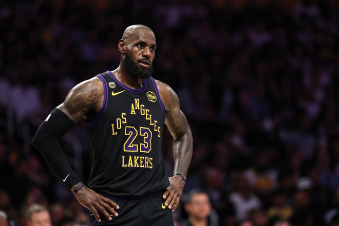 LeBron James in Los Angeles Lakers jersey during NBA playoff game with uncertain expression about retirement decision