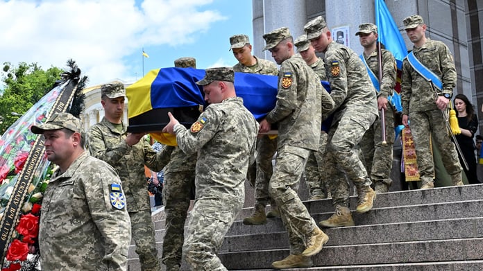 Russian and Ukrainian officials during a humanitarian exchange of fallen soldiers amid the ongoing Ukraine conflict