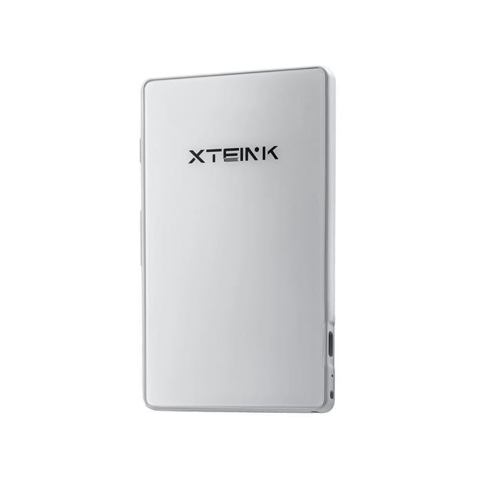 Xteink X4 tiny magnetic e-reader attached to smartphone showing e-ink display