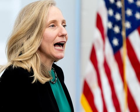 Virginia Governor Abigail Spanberger stands in front of an American flag