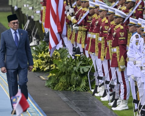 Malaysian Prime Minister Anwar Ibrahim inspects an honour guard during an official visit