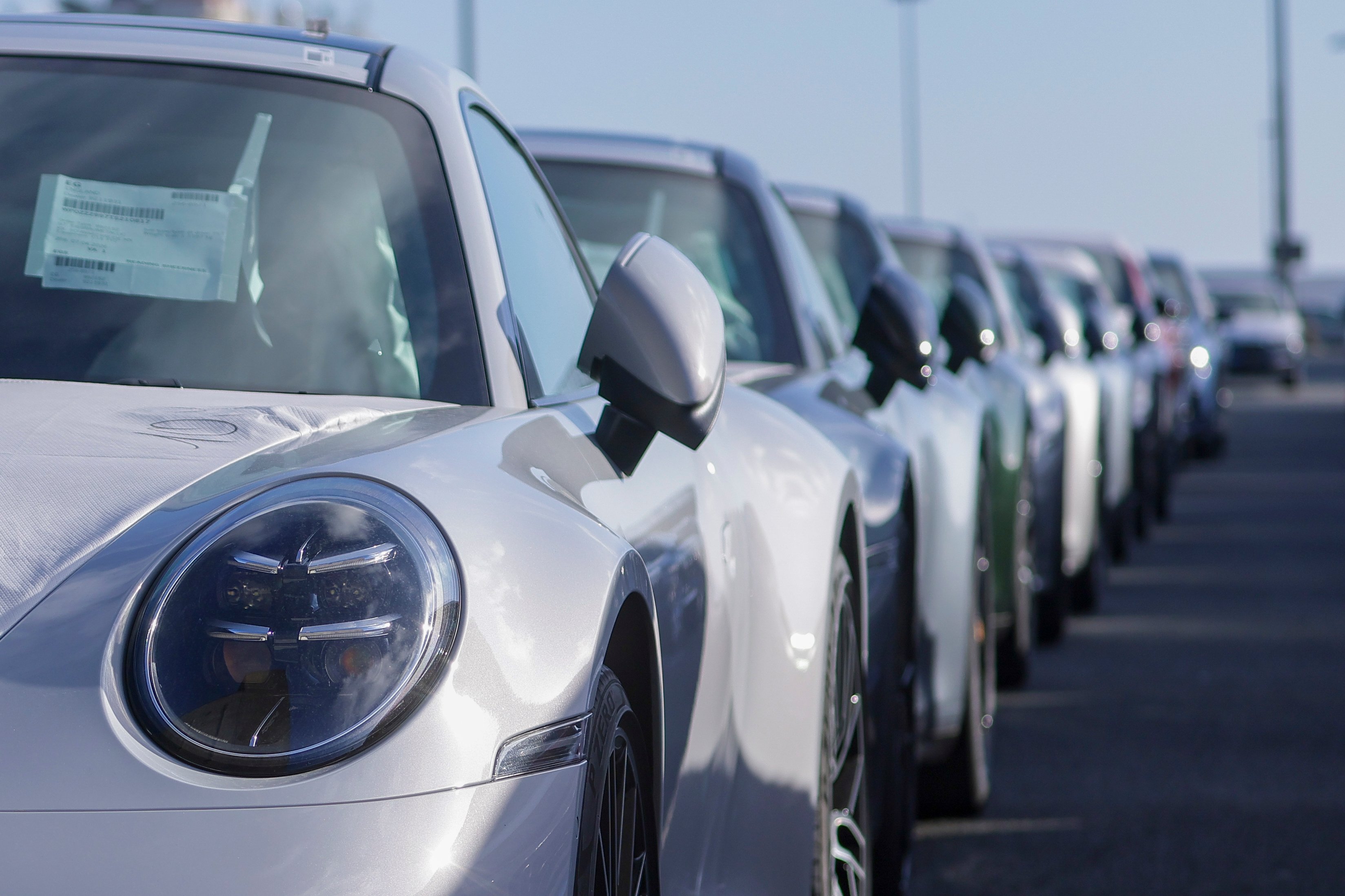 Rows of vehicles awaiting export shipment at a port facility