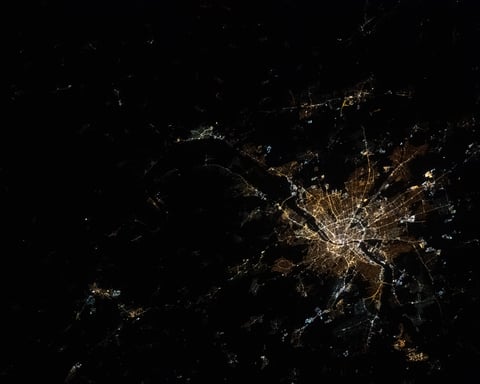 NASA astronaut photograph from ISS of Budapest Hungary at night showing Danube River dividing Buda Pest Obuda