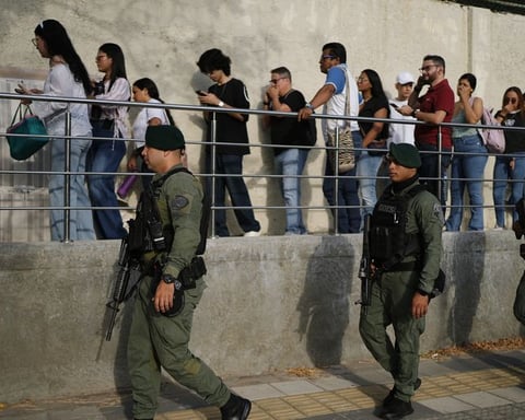Soldiers patrol as voters arrive at a polling station during Colombia's presidential election in Barranquilla
