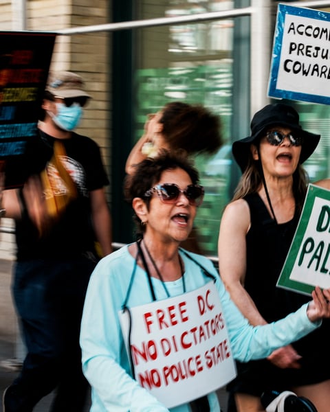 Protesters hold signs reading defund Palantir during a march outside Palantir's offices in New York