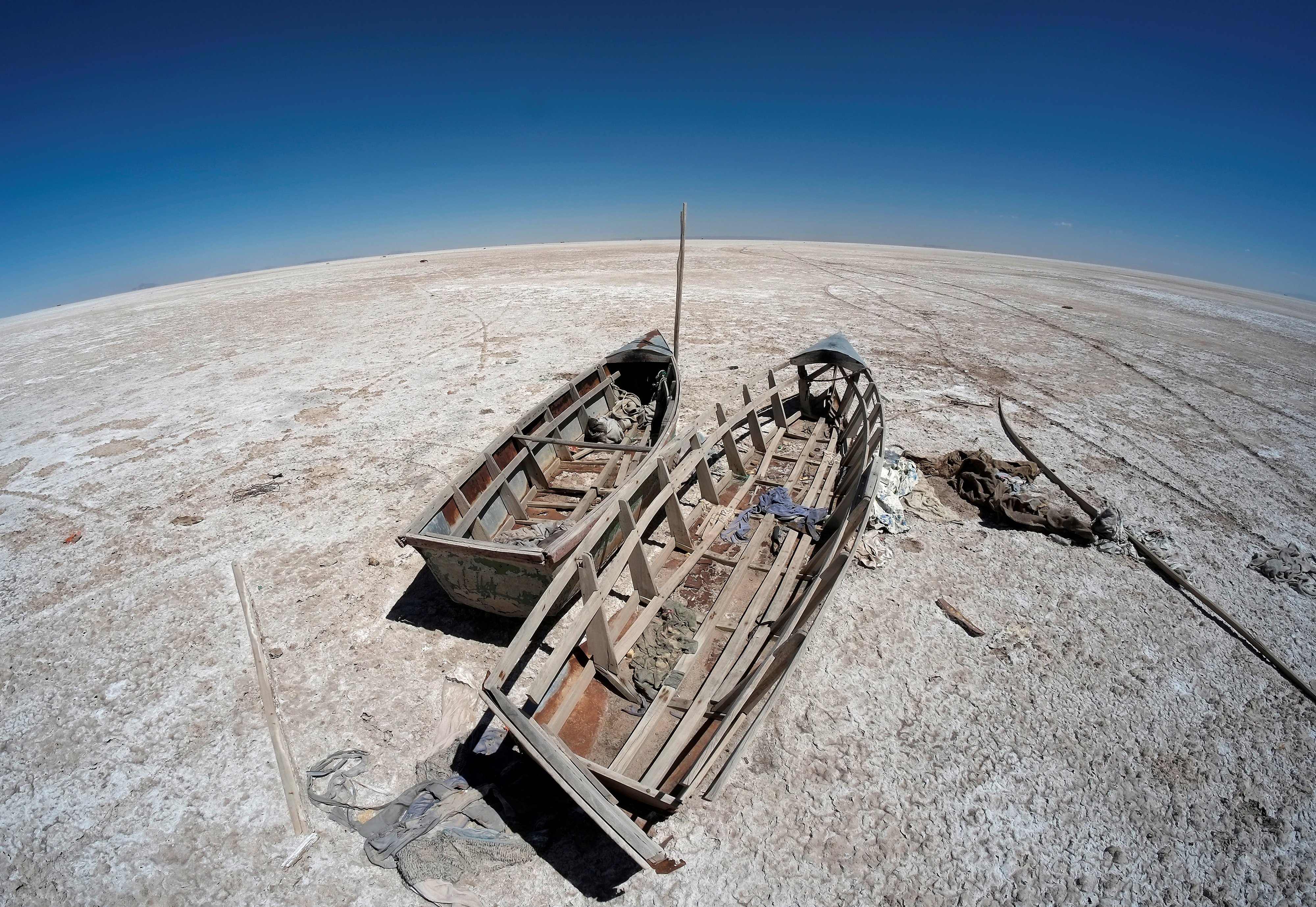 Abandoned boats sit on the dried basin of Lake Poopo in Bolivia, an extreme example of the kind of reservoir loss climate scientists associate with warming