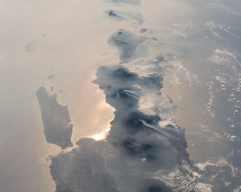 NASA astronaut photograph from the International Space Station showing nearly half the length of Indonesia's main island chain with Java Bali Lombok Sumba and Timor visible against the Indian Ocean