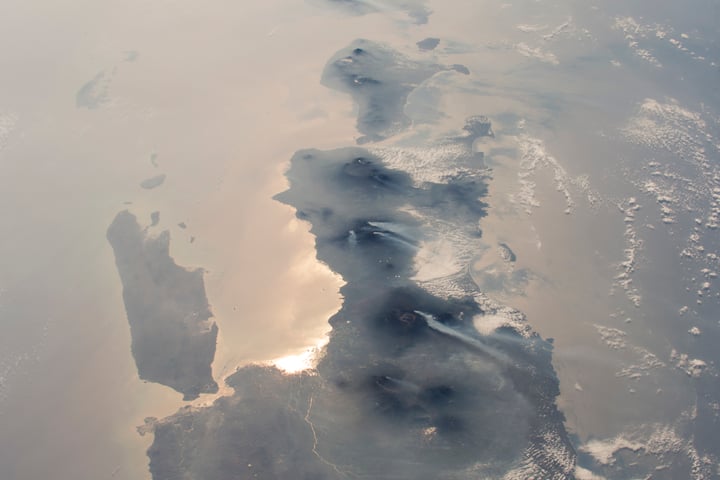 NASA astronaut photograph from the International Space Station showing nearly half the length of Indonesia's main island chain with Java Bali Lombok Sumba and Timor visible against the Indian Ocean