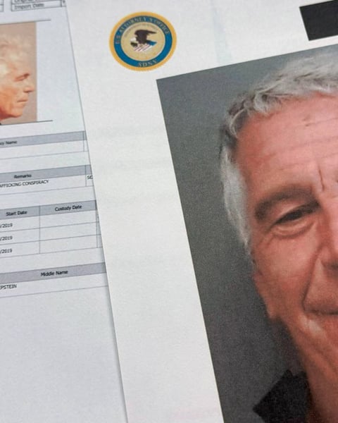 DOJ-released Epstein files documents photographed on a desk