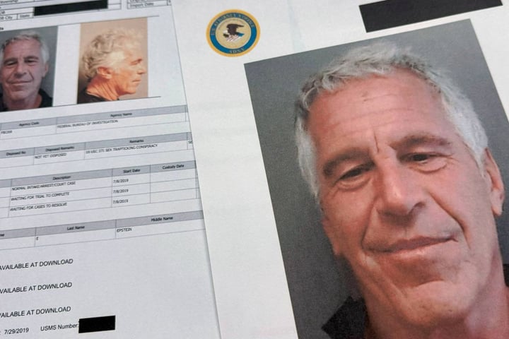 DOJ-released Epstein files documents photographed on a desk