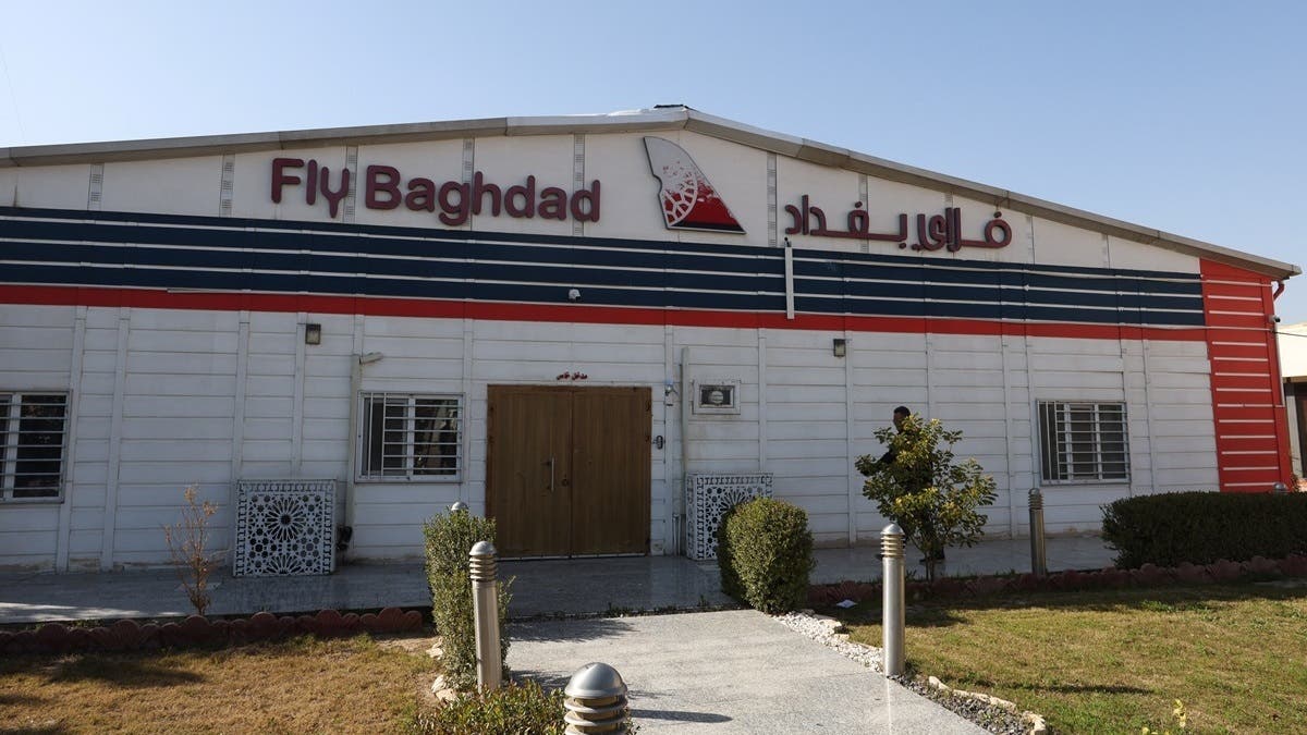 Person walks outside Fly Baghdad airline office at Baghdad International Airport, Iraq