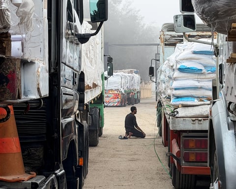 Trucks carrying humanitarian aid lined up at the Rafah border crossing into Gaza
