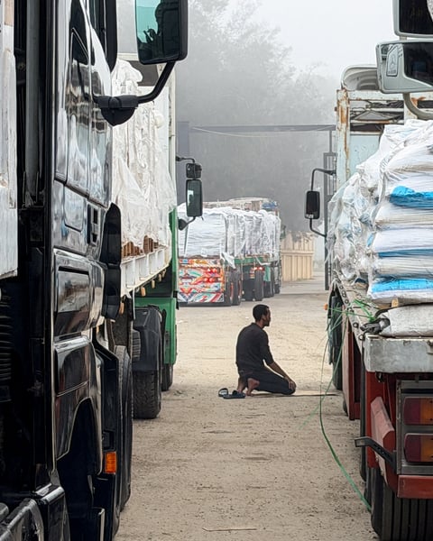 Trucks carrying humanitarian aid lined up at the Rafah border crossing into Gaza