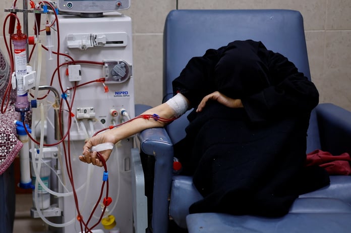 A Palestinian woman with kidney failure undergoes dialysis in Gaza while hoping to leave for treatment abroad