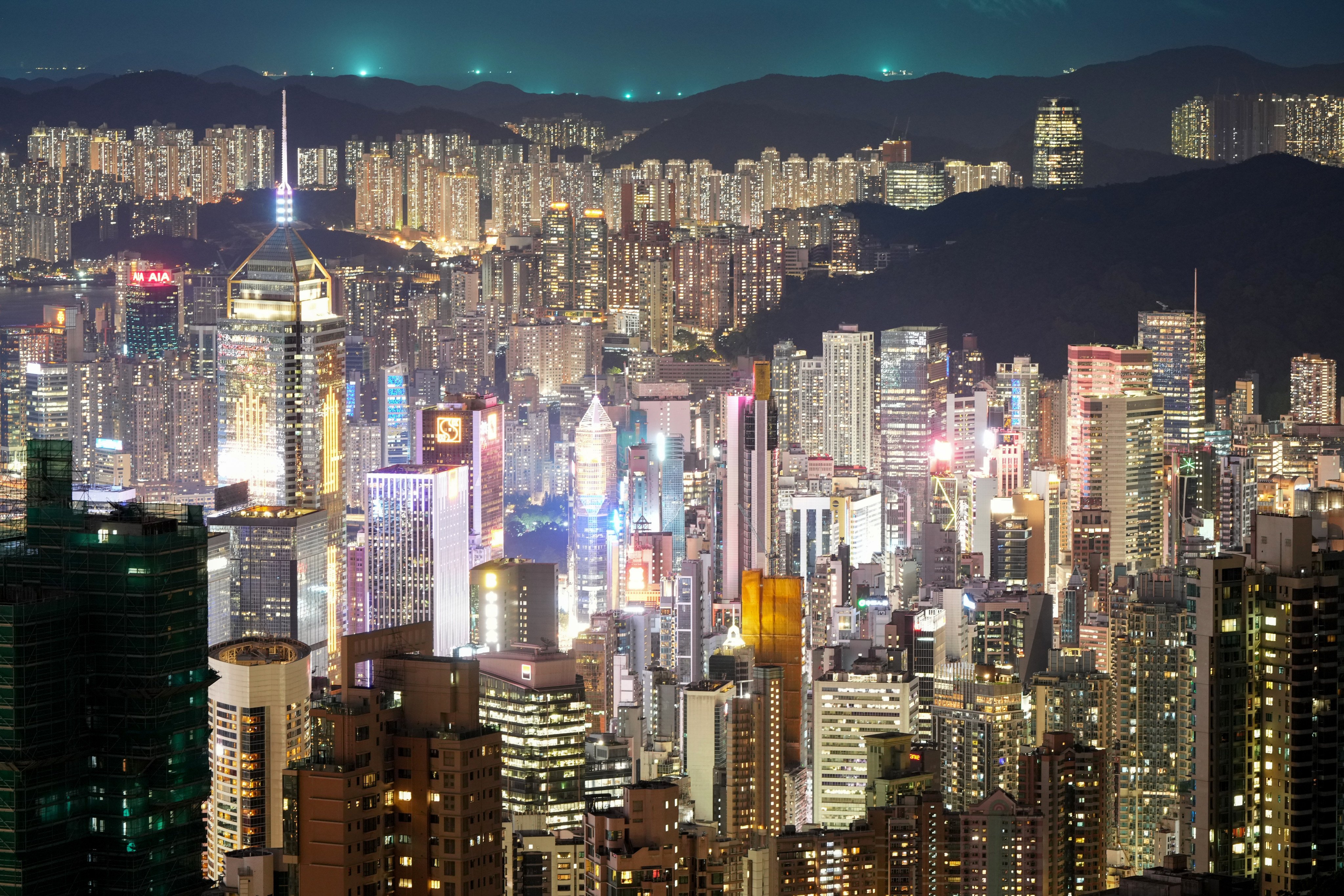 Hong Kong skyline at night as luxury residential property cycle turns and mainland Chinese Singaporean buyers return